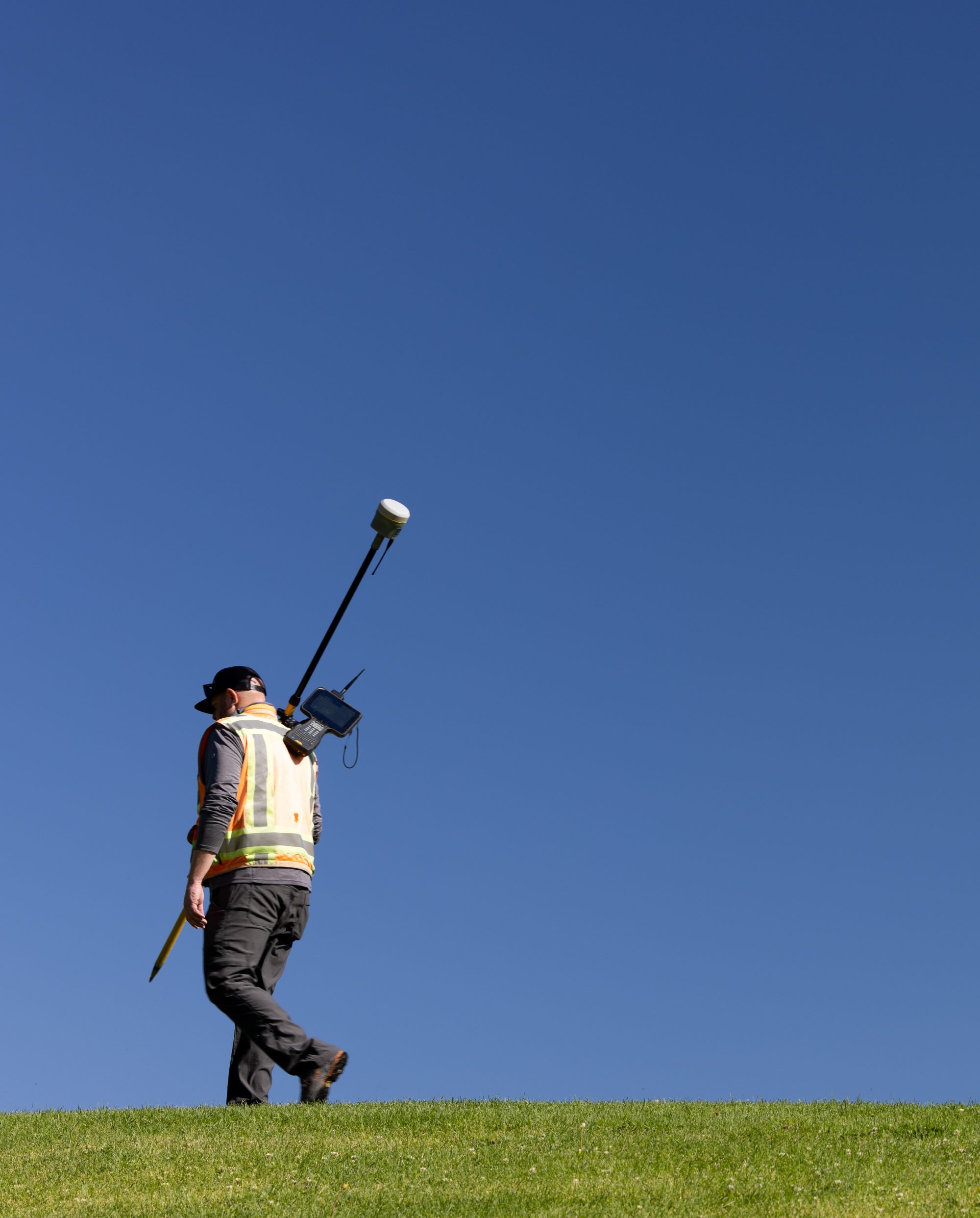 Surveyor carrying a total station